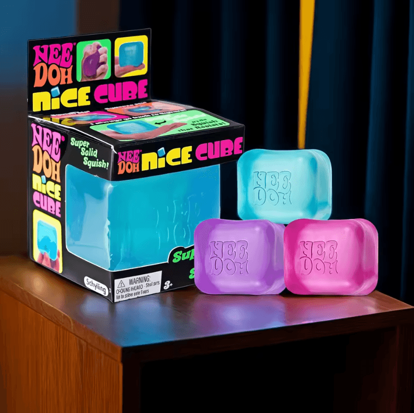 Four ice-cube squishy toys in blue, green, purple, and pink